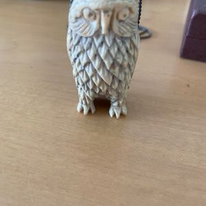Vintage carved bone owl pendant with silver chain.